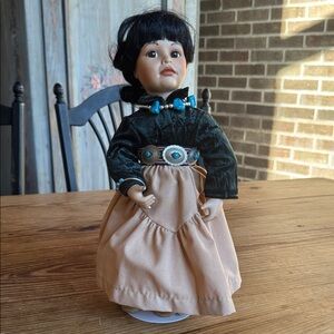 Navajo Little One a fine porcelain doll inspired by the art of Ray Swanson